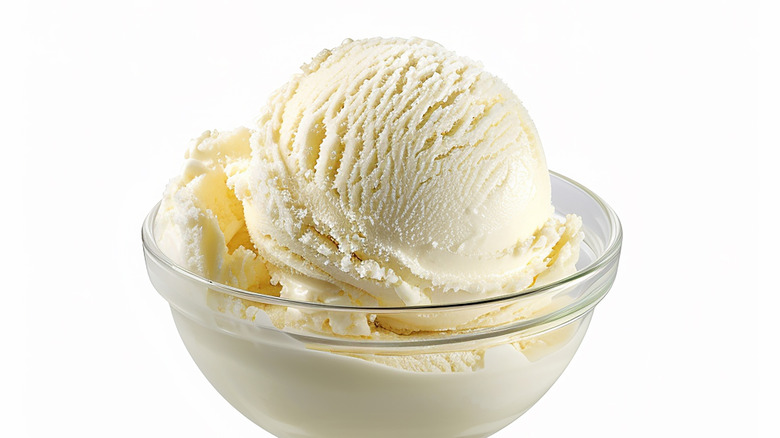 Vanilla ice cream scooped into a glass dish
