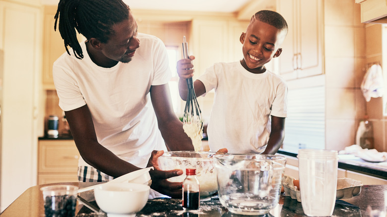 Father and son whisking batter