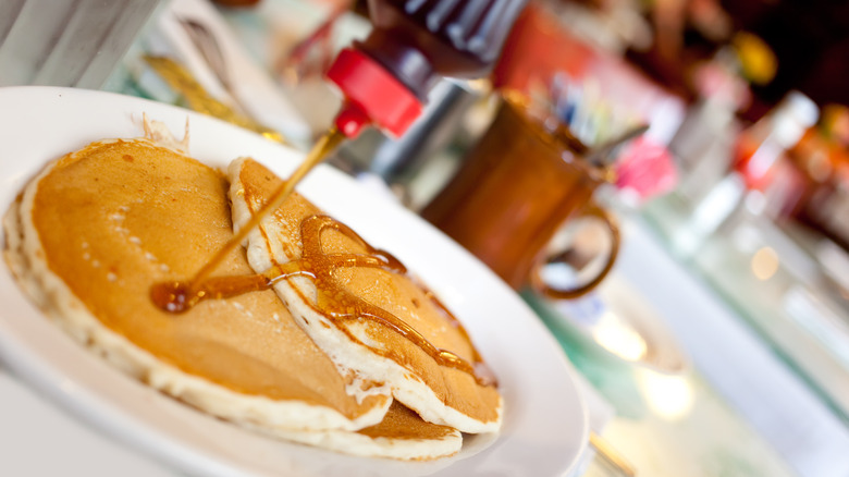 Syrup pouring on pancakes