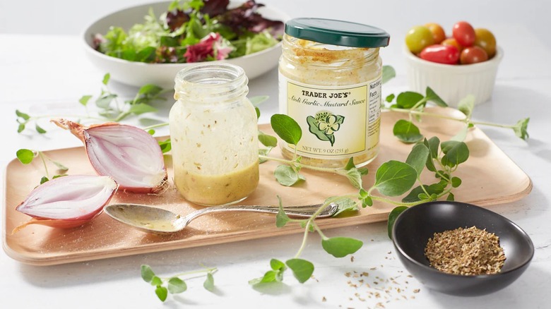 Aioli Garlic Mustard Sauce from Trader Joe's with a salad in the background.