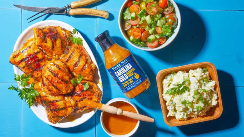 Carolina Gold Barbeque Sauce from Trader Joe's with BBQ chicken, salad, and potato salad.