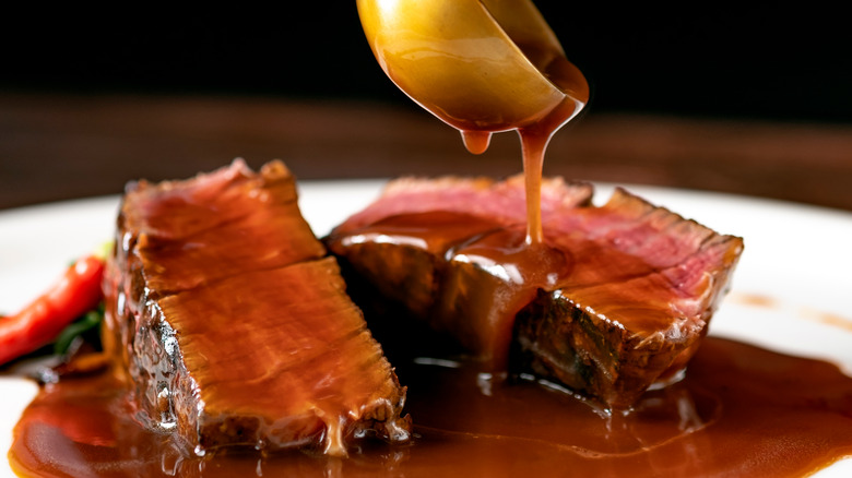 Steak sauce pouring on steak