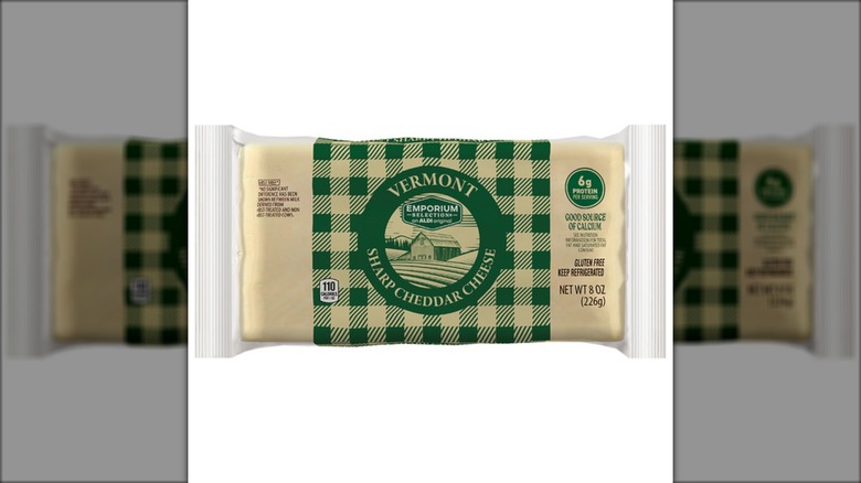 A package of Emporium Selection Vermont Sharp Cheddar Cheese from Aldi