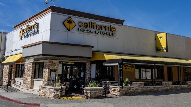 A California Pizza Kitchen exterior on the corner.