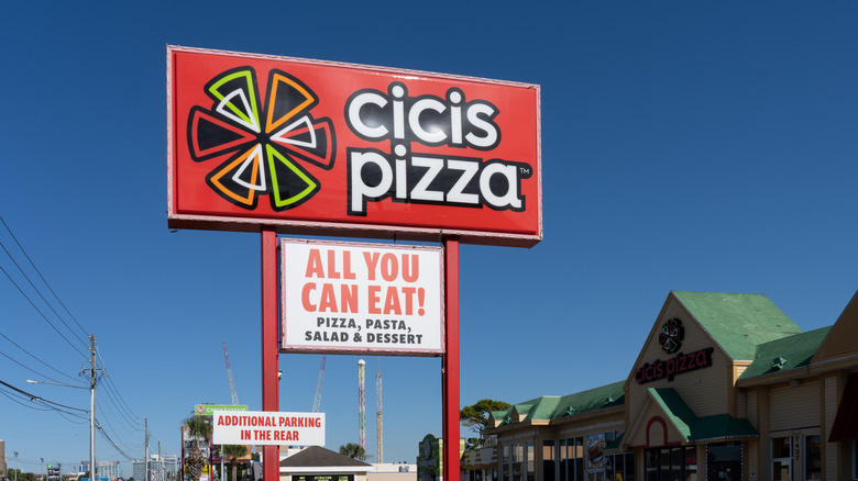A sign for Cicis pizza advertising all you can eat pizza, pasta, salad, and dessert.