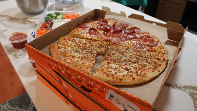 An open box of Little Caesars half-pizza, half-breadsticks.