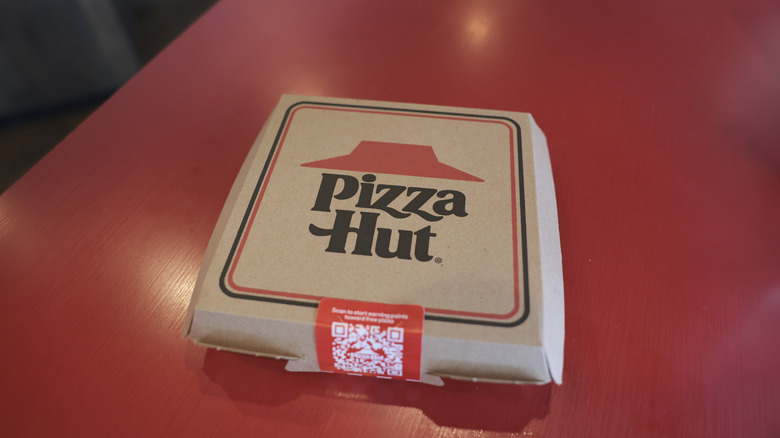 A closed box of Pizza Hut pizza.