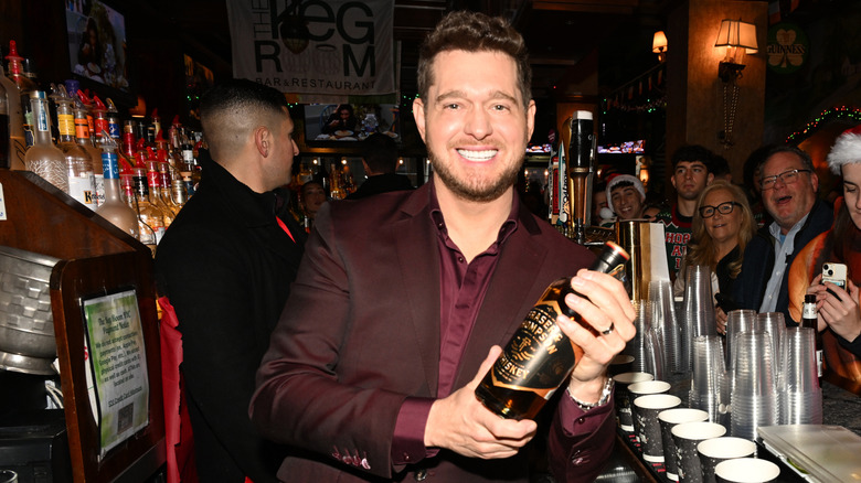 Michael Buble holds a bottle of Fraser & Thompson whiskey.