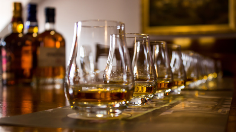 A line of snifter glasses with whiskey