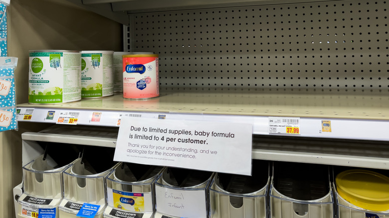 Mostly empty shelf of baby formula during supply shortage