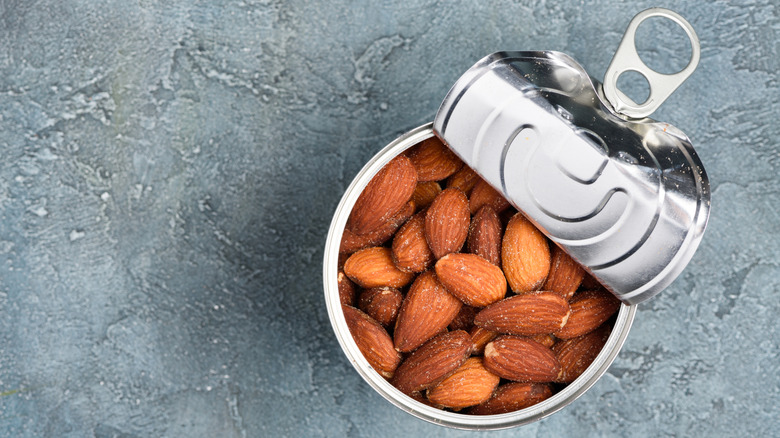 Can of almonds with pop top peeled back with a gray background