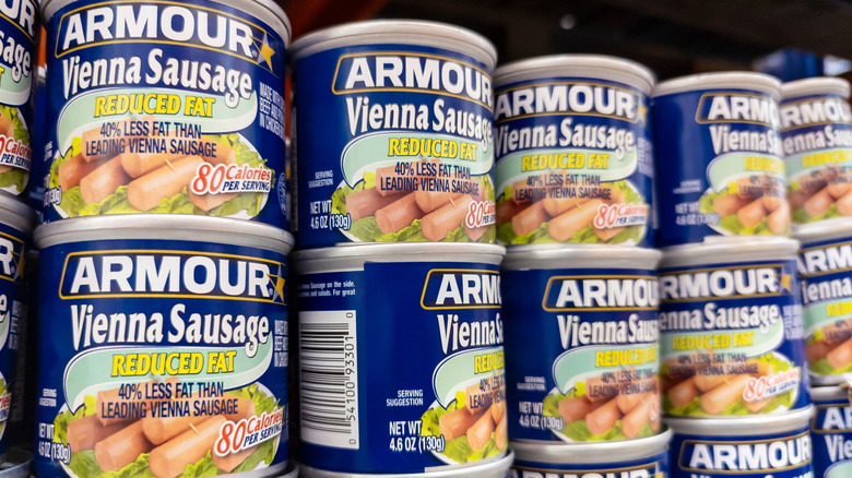 Shelf stacked with cans of Vienna sausage