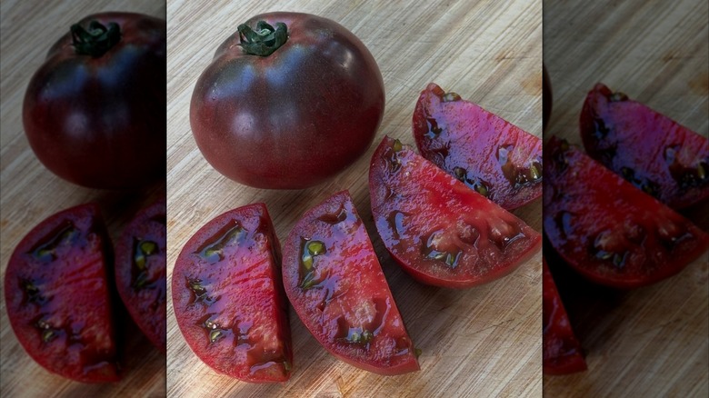 Whole and sliced Cherokee purple tomatoes