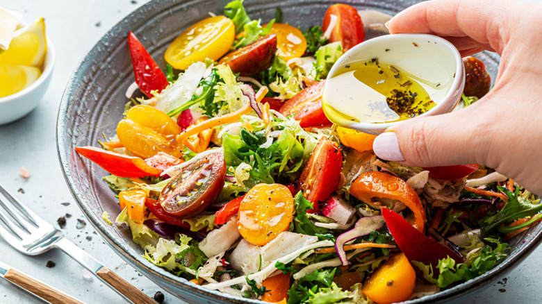 A colorful salad full of tomatoes, peppers, and other vegetables