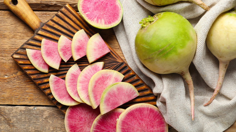 Sliced and whole watermelon radishes on a table