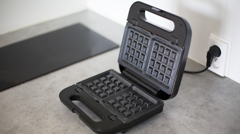 Waffle iron plugged into wall