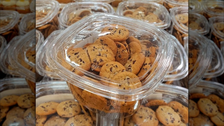 A container of the bite size Costco cookies sits on top of a display of others in Costco