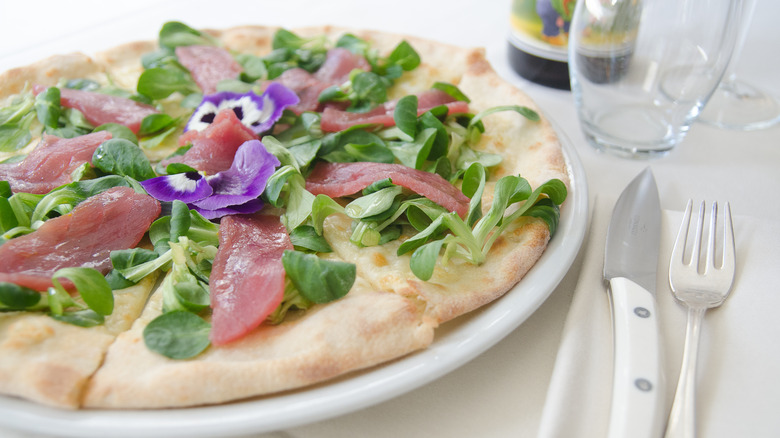 California-style pizza with cutlery