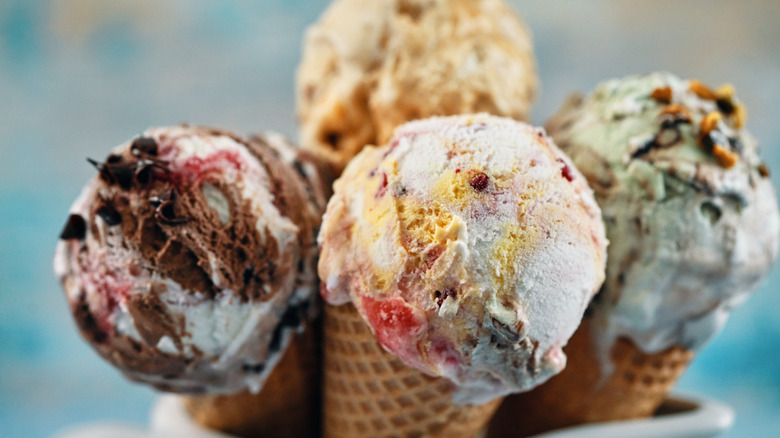 four ice cream scoops in waffle cones