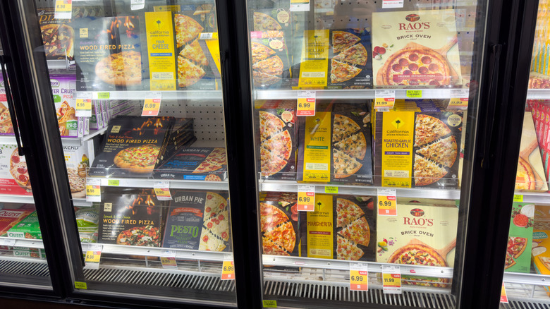 Freezer filled with assorted pizza brands