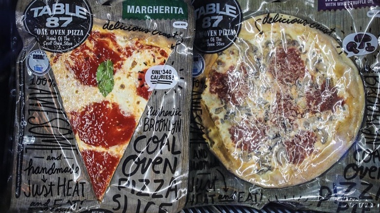 Packages of Table 87 coal oven pizza in a store cooler