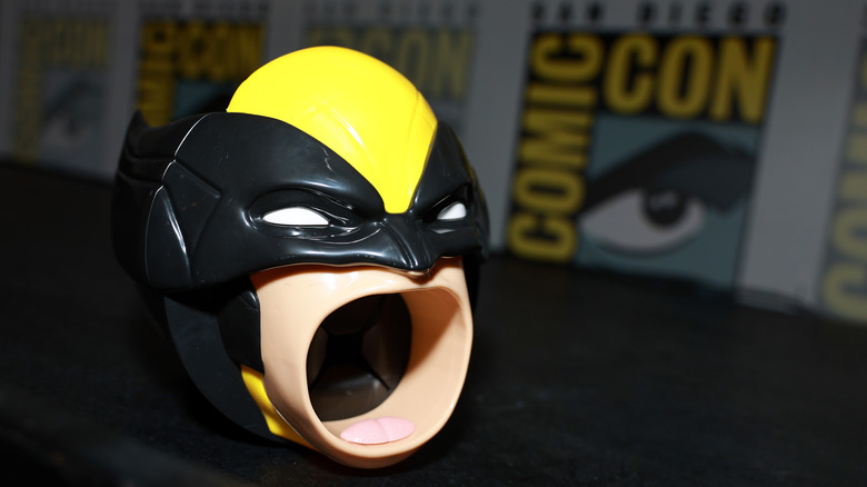 Wolverine head popcorn tub against a blurred Comic-Con backdrop