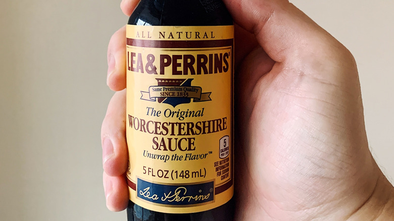 Hand holding bottle of Lea & Perrins Worcestershire sauce