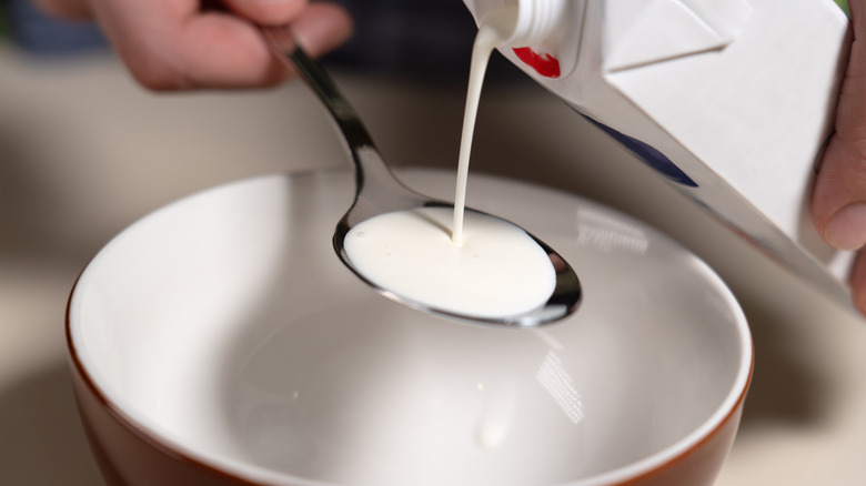 Pouring cream into a spoon