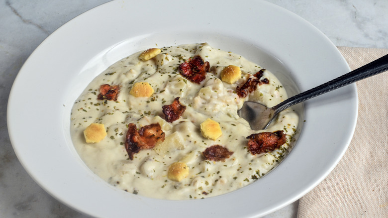Bowl of clam chowder with bacon crumbles