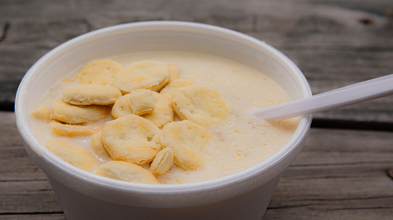 Bowl of clam chowder with oyster crackers on top