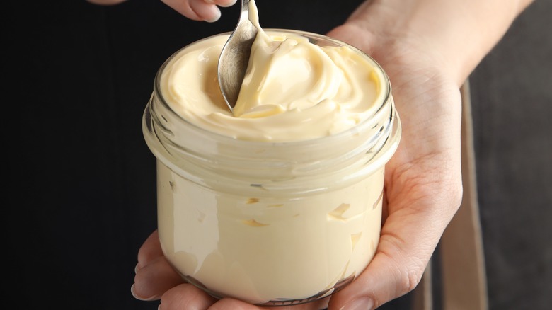 Woman holding jar of mayonnaise