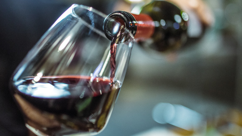 red wine pouring into glass