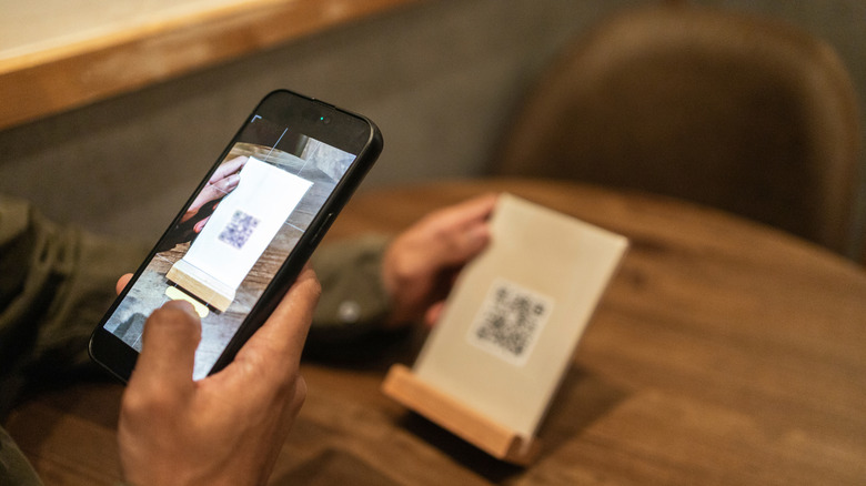 A man scanning a QR code menu