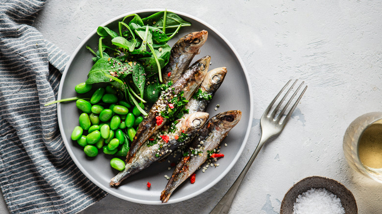 Tiny portion of fish with green vegetables
