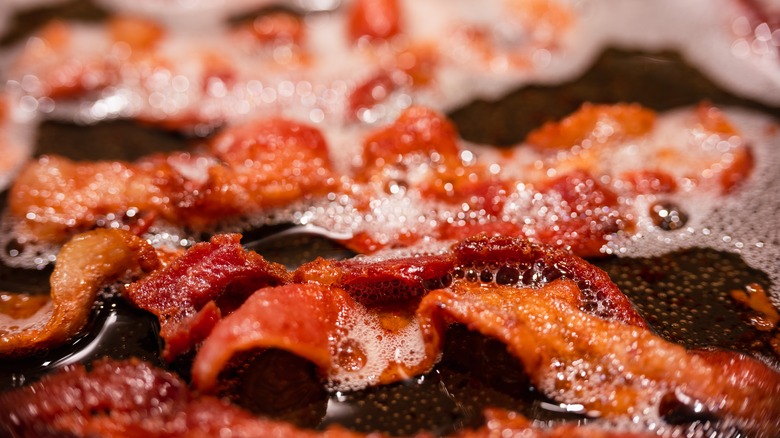 bacon cooking in frying pan