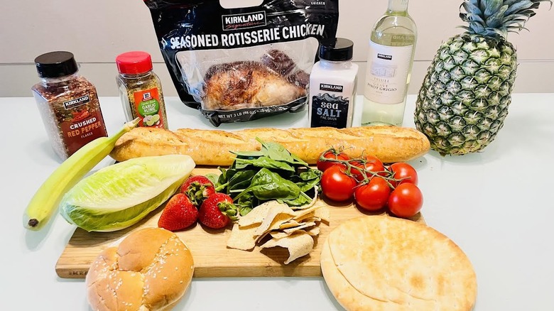 Collection of inexpensive Costco products laid out on table and cutting board