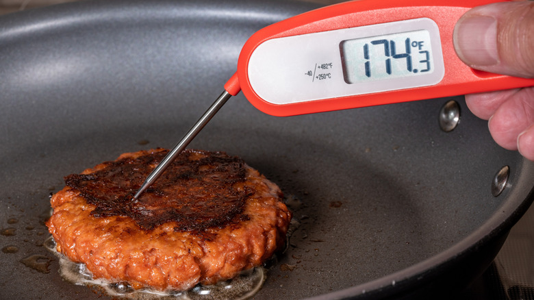 Meat thermometer in burger patty