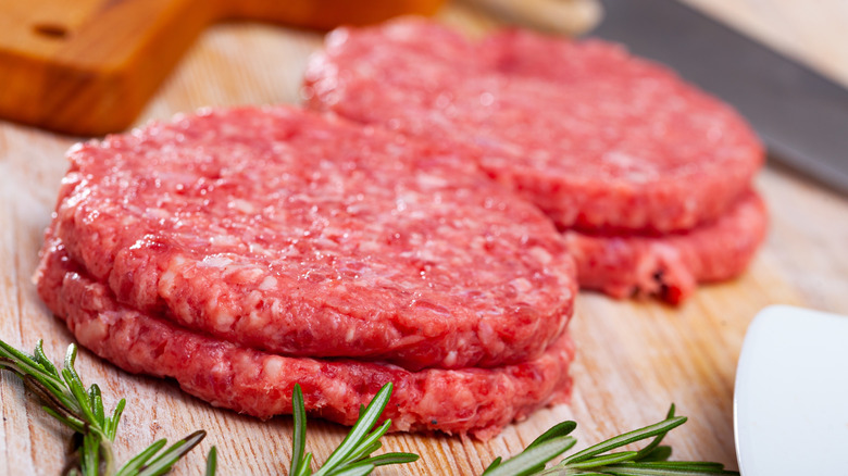 Raw hamburger patties stacked on one another
