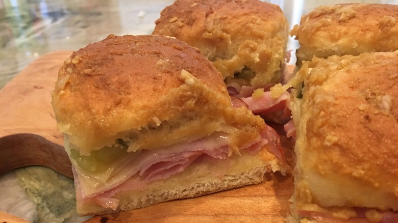 Cubano sliders sit on a cutting board