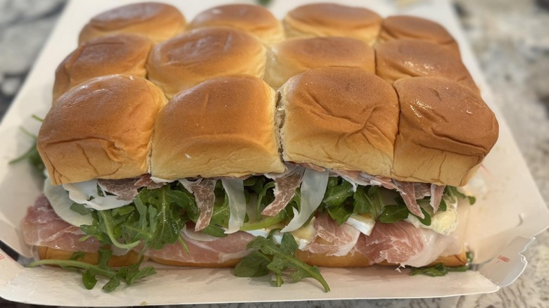 Charcuterie sliders sit on a serving tray.