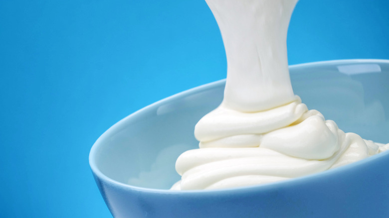 pouring greek yogurt in bowl