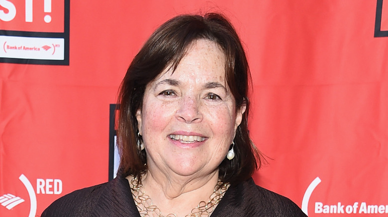 Ina Garten standing on red background