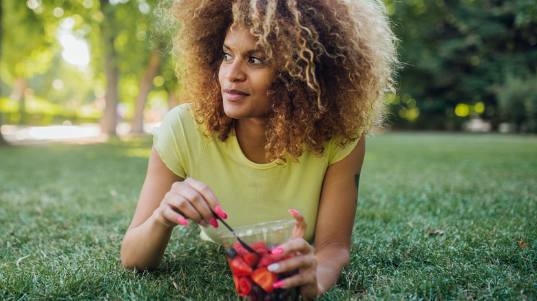 woman eating strawberries