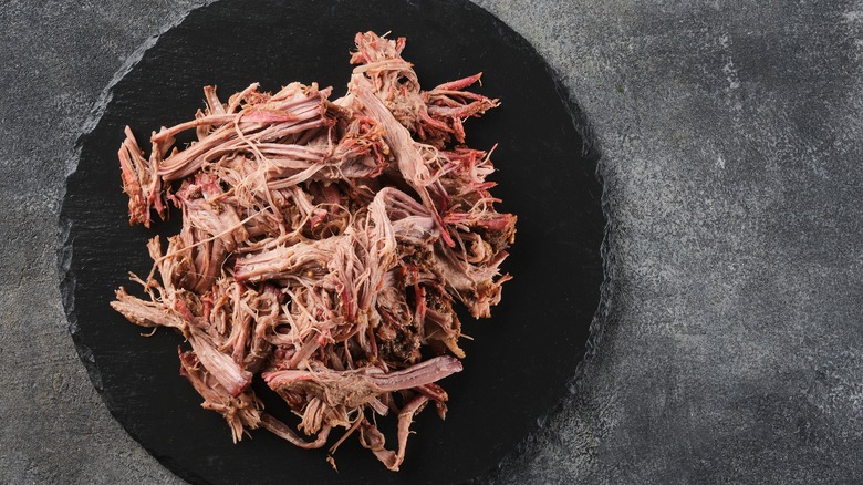 shredded pulled pork on slate