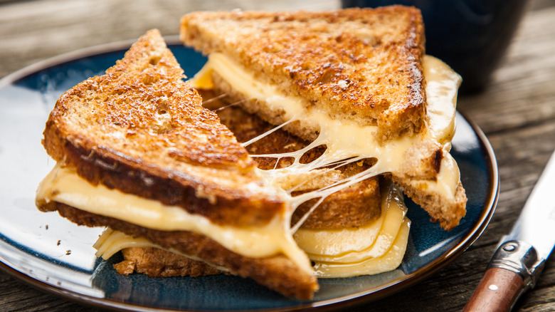 Cut grilled cheese with knife