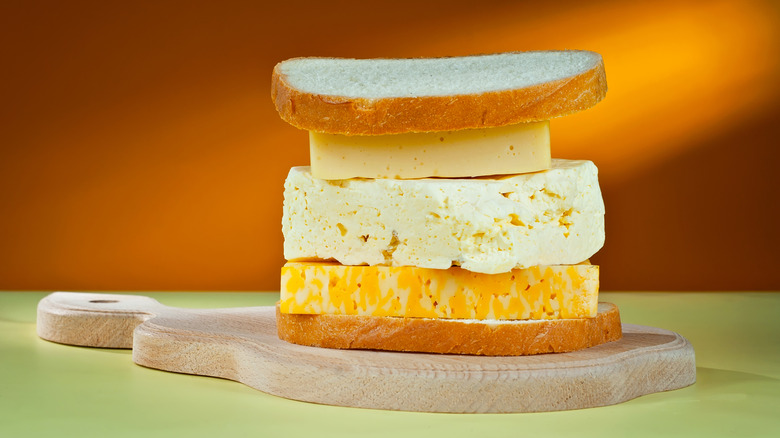 Stack of cheeses between bread