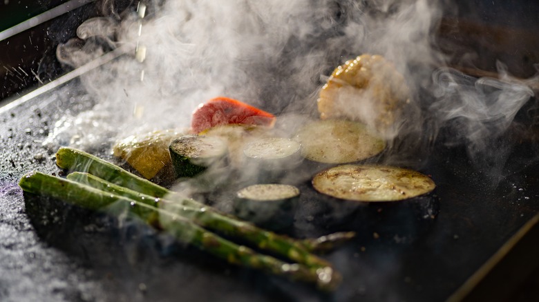vegetables smoking on griddle