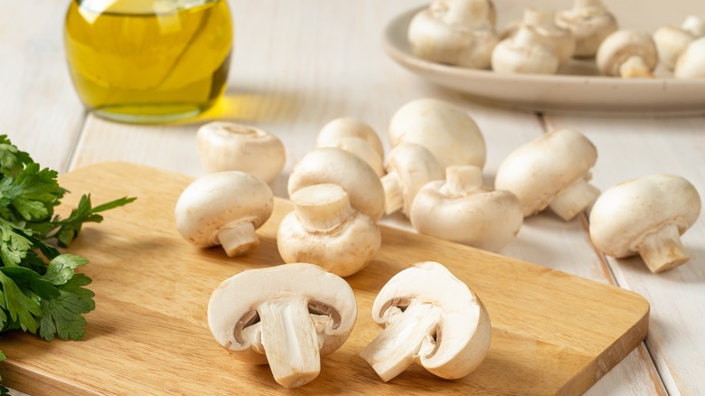 White button mushrooms on board