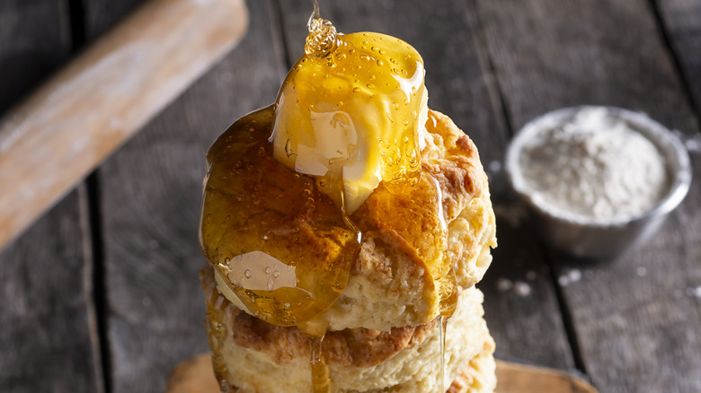 drizzling honey on biscuit