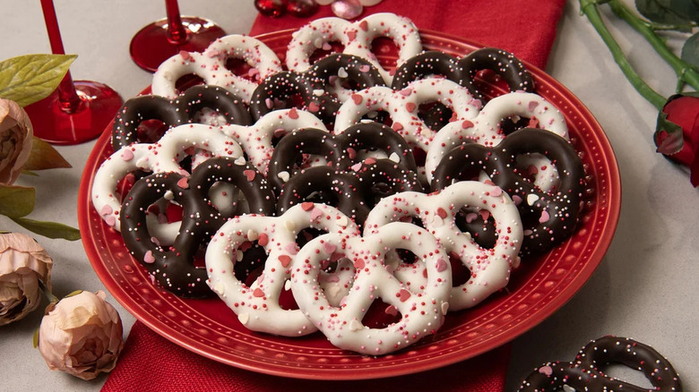 An assortment of Sweet Penny Valentine's Day pretzels is arranged on a red plate